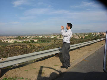 Coro fellow Joaquin Beltran takes a photo of the view from the IRWD San Joaquin Reservoir.